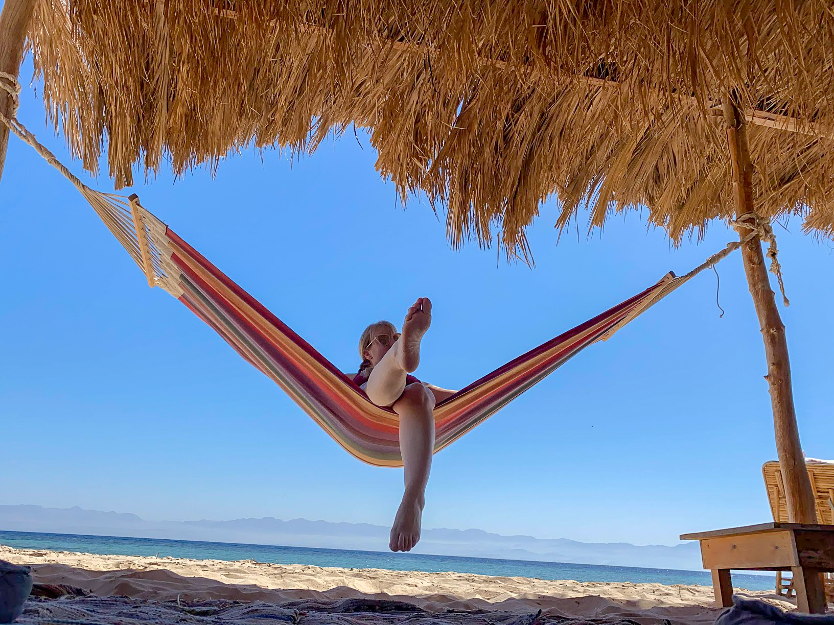 Rosie sitting in a hammock on the beach at Aqua Sun Beach Camp, Sinai, Egpyt