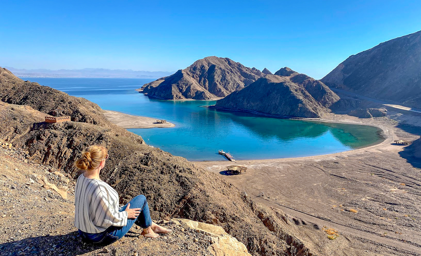 Rosie sits looking over Fjord Bay in the Gulf of Aqaba, Egypt