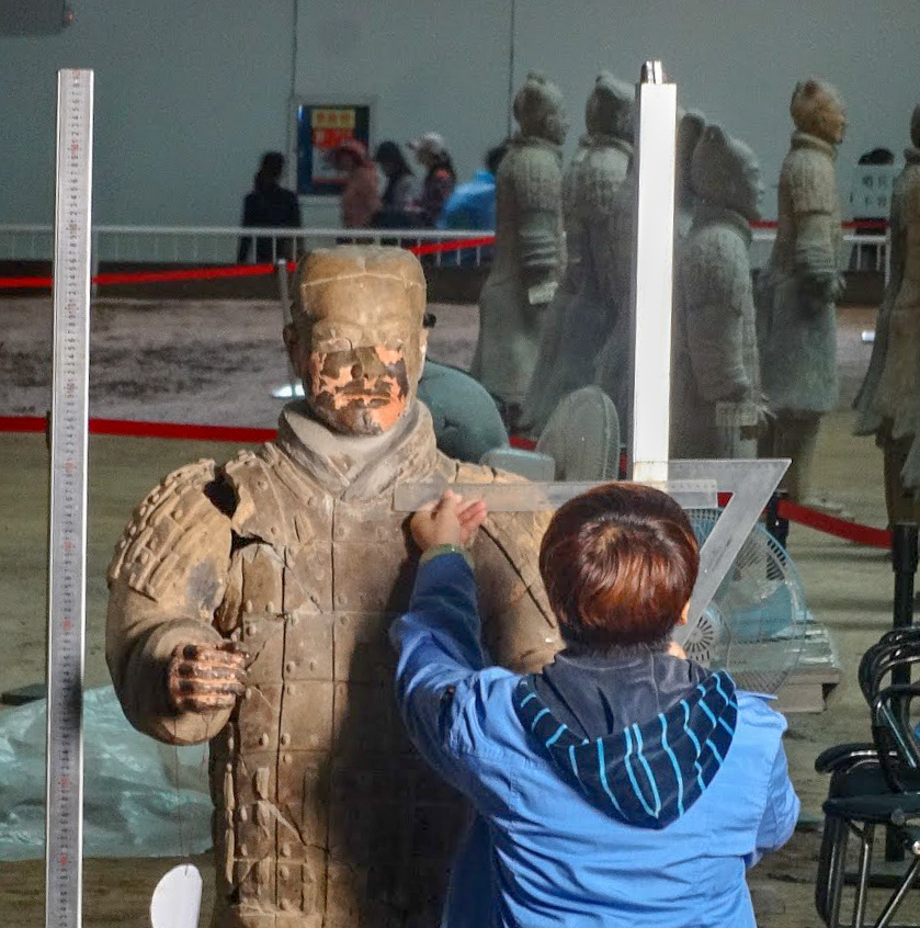 An archeologist measures the shoulder of a Terracotta Warrior of the Terracotta Army at Emperor Qinshihuang's Mausoleum, Xian, China