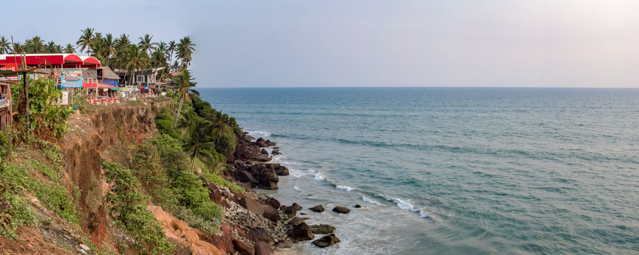 The red cliffs of Varkala beach and the Arabian Sea against the rocks, Varkala, Kerala, India