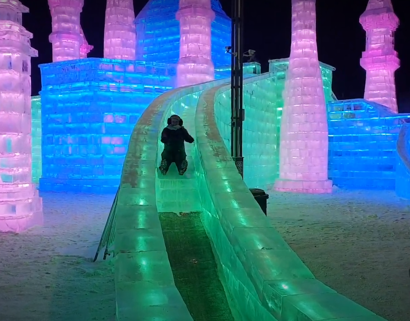 Rosie on a green ice slide at Harbin Ice and Snow World