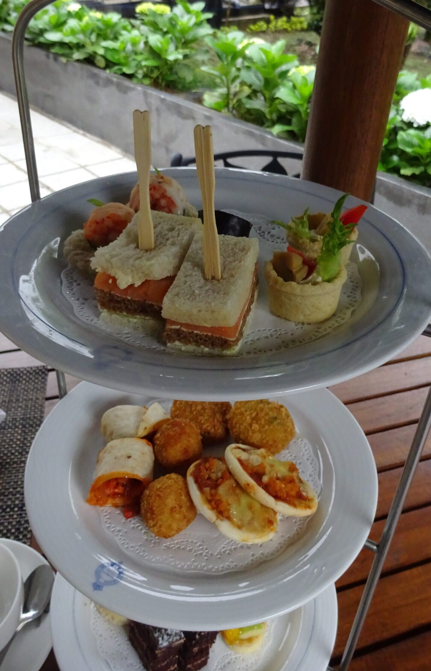 High tea 3 tiered stand with sandwiches and cake at The Grand Hotel, Nuwara Eliya, Sri Lanka