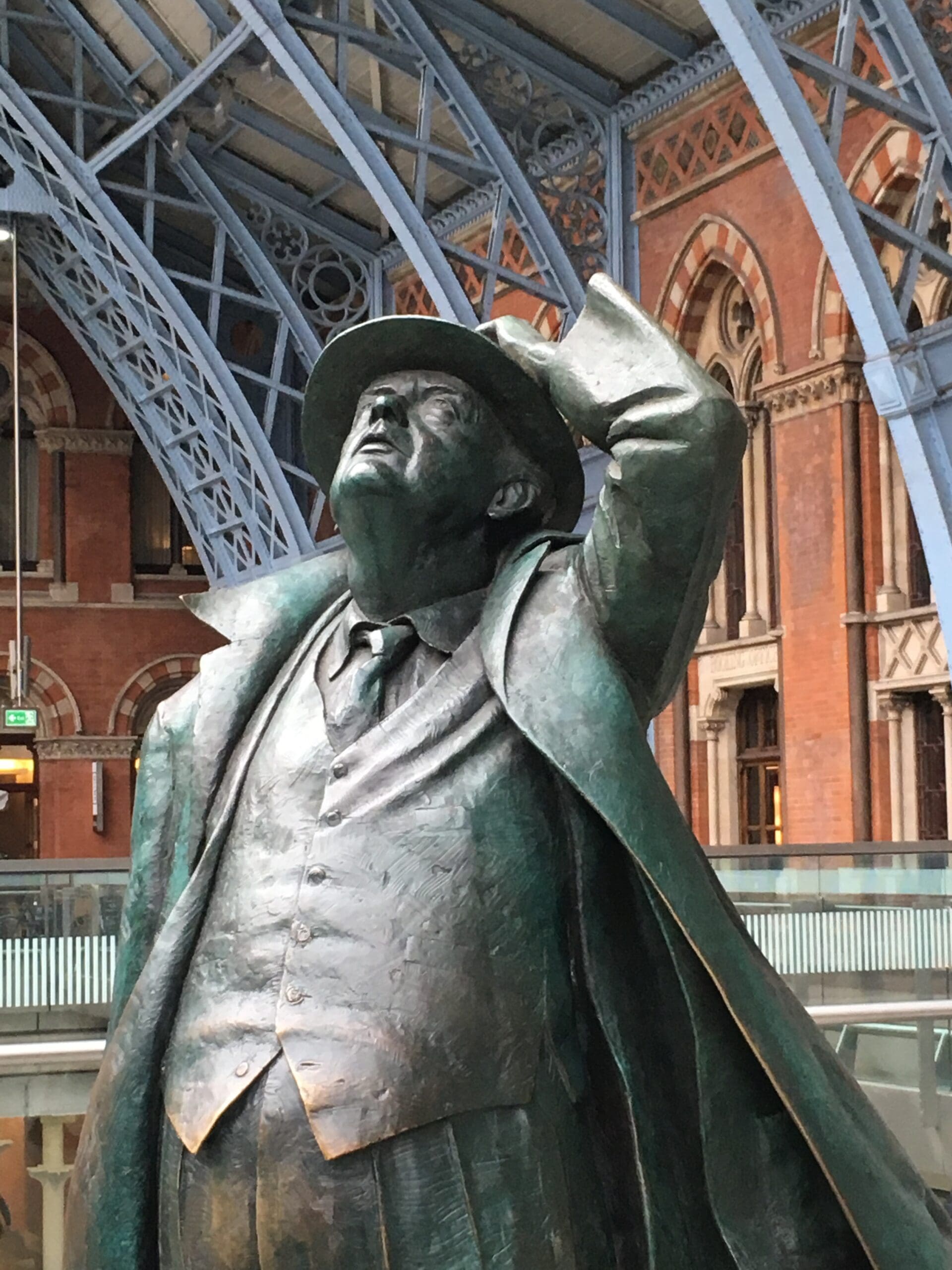 bronze statue of John Betjeman in St Pancras railway station, London