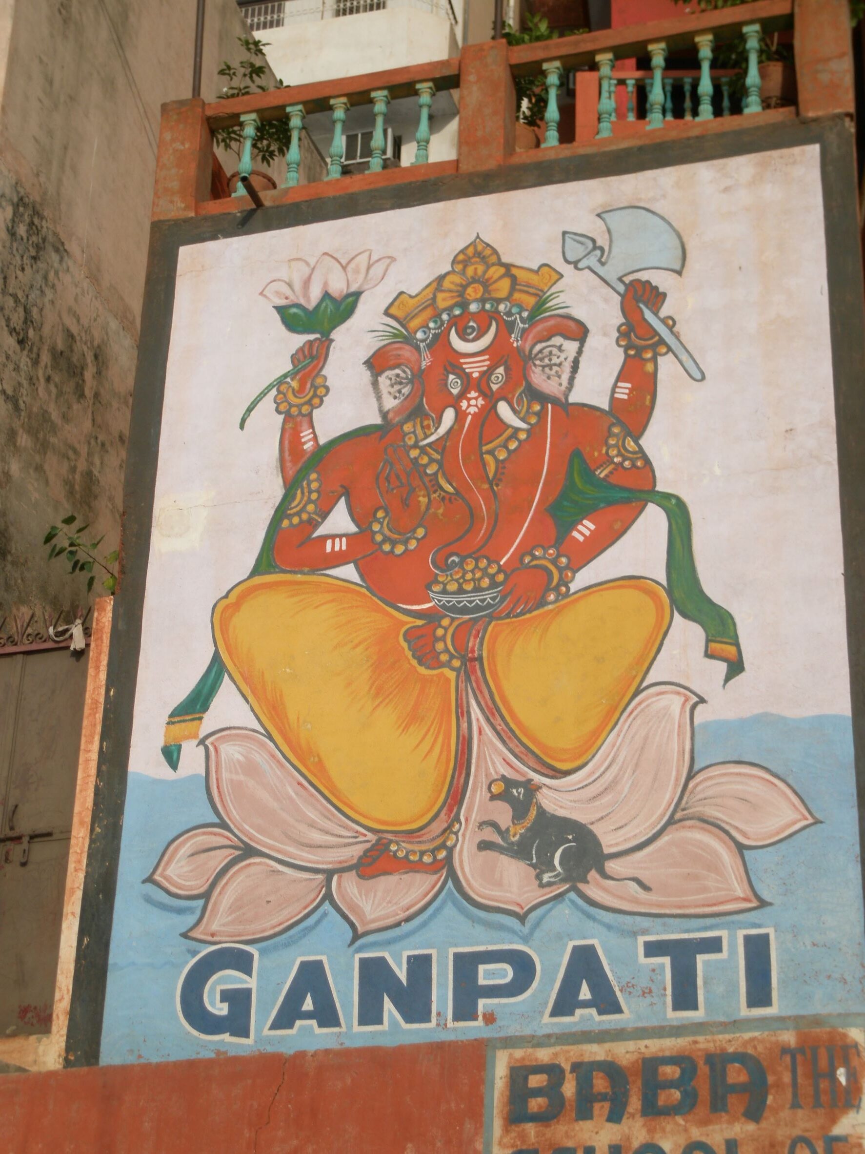 Ganpati Guesthouse mural painted on a wall with a red Ganesha, Varanasi, India